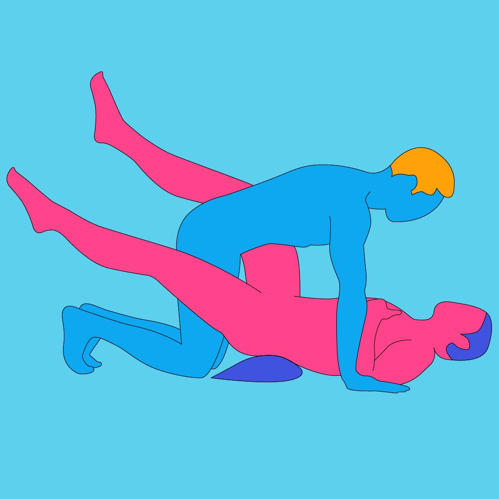 A couple are together in an intimate scene with a blue backdrop.